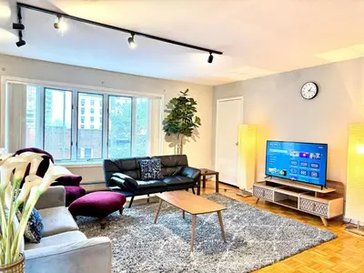 a living room with a couch and a tv at Huge Place Minutes from NYC Parking Available in Guttenberg