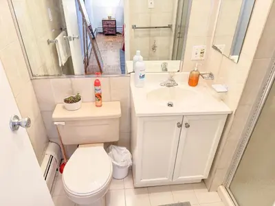 a bathroom with a toilet and a sink at Spacious and Convinient near NYC Parking Available in Guttenberg