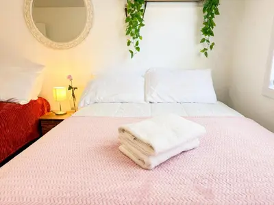 a bedroom with two beds with towels on the bed at Spacious and Convinient near NYC Parking Available in Guttenberg