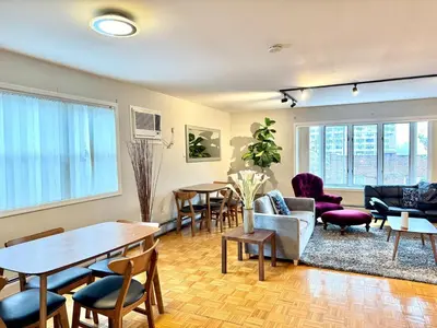 a living room with a table and chairs at Spacious and Convinient near NYC Parking Available in Guttenberg