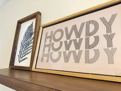a framed picture on a shelf next to a mirror at Spacious and Convinient near NYC Parking Available in Guttenberg