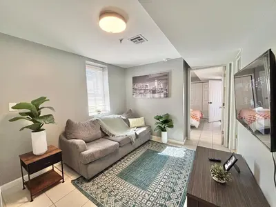 a living room with a couch and a table at FREE Parking Cozy 2 Bedroom unit near NYC in North Bergen