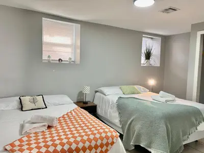 a bedroom with two beds and two windows at FREE Parking Cozy 2 Bedroom unit near NYC in North Bergen
