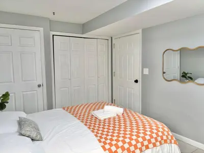 a bedroom with a bed with a mirror on the wall at FREE Parking Cozy 2 Bedroom unit near NYC in North Bergen