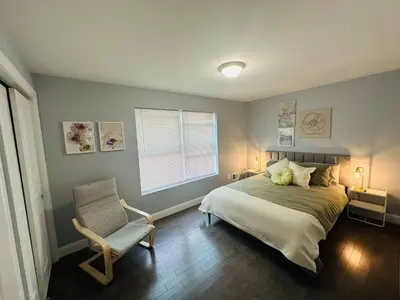a bedroom with a bed and a chair and a window at 15% OFF | EWR| NYC | Metropolis Serenity Haven in Newark