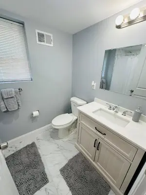 a bathroom with a sink and a toilet and a mirror at 15% OFF | EWR| NYC | Metropolis Serenity Haven in Newark