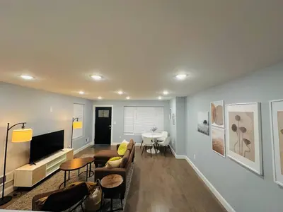 a living room with a couch and a table at 15% OFF | EWR| NYC | Metropolis Serenity Haven in Newark