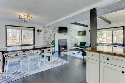 a kitchen with a table and chairs and a fireplace at Modern 4 Bedroom Home with Sauna and Game Room in Gated Lake Community in East Stroudsburg