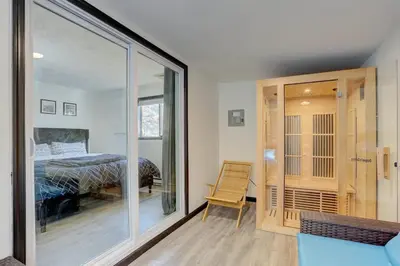 a bedroom with a bed and a sliding glass door at Modern 4 Bedroom Home with Sauna and Game Room in Gated Lake Community in East Stroudsburg