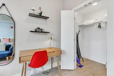 a room with a desk and a red chair at Floor To Ceiling Windows- Bridge Views - Studio in Philadelphia
