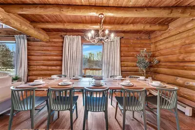 a dining room with a wooden table and chairs at 5BR Lux Cabin w HotTub Sauna Pool FirePit GameRoom in East Stroudsburg