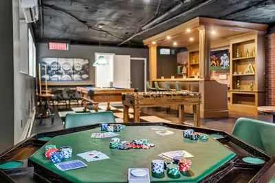 a room with a table with poker chips on it at 5BR Lux Cabin w HotTub Sauna Pool FirePit GameRoom in East Stroudsburg