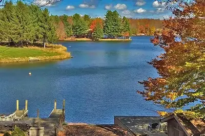 a view of a large lake in the fall at Designer Poconos Chalet I Ski, Skate, Lakes, Family-Friendly in Lake Ariel