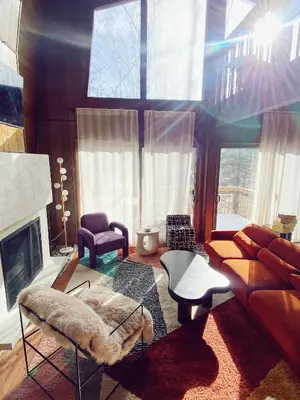 a living room with a couch and a fireplace at Designer Poconos Chalet I Ski, Skate, Lakes, Family-Friendly in Lake Ariel