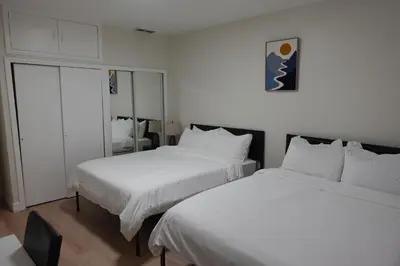 a hotel room with two beds with white sheets at HouseDF in Bayonne