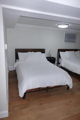 a bedroom with two beds with white sheets at HouseDF in Bayonne