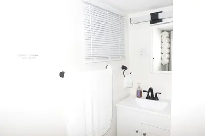a white bathroom with a sink and a mirror at HouseDF in Bayonne