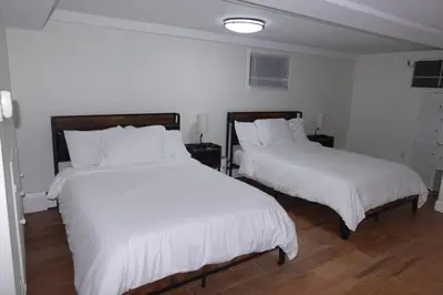 two beds in a room with white sheets at HouseDF in Bayonne
