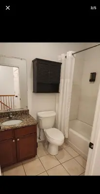 a bathroom with a toilet and a shower and a sink at The LOFT in Rahway