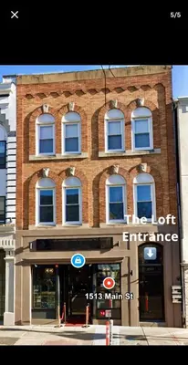 a large brick building with a sign on it at The LOFT in Rahway