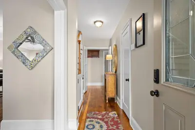 a hallway with a mirror next to a door at 3BD 102 Madison Ter in Springfield