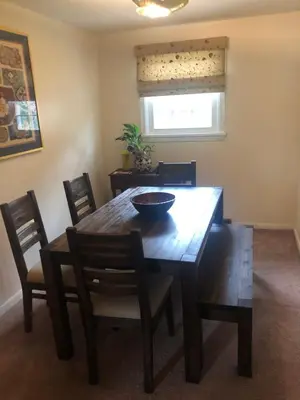 a dining room table with chairs and a bowl on it at Quiet Harrisburg home in Harrisburg