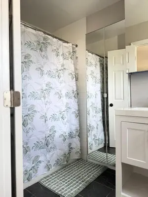 a shower in a bathroom with a shower curtain at 15 mins to NYC-Great Apartment Great for Family in West New York