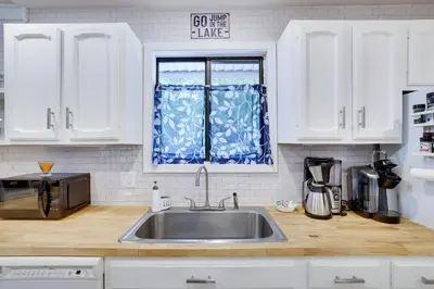 a kitchen with a sink and a window at Emerald Escape Lake, Theater, Game Room & More! in Long Pond