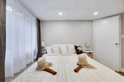 a bedroom with a large bed with two towels on it at Emerald Escape Lake, Theater, Game Room & More! in Long Pond