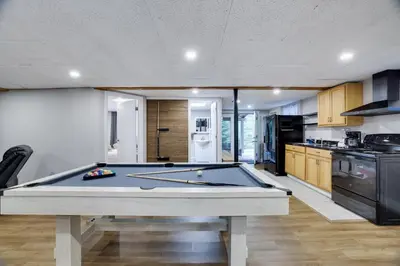 a pool table in the middle of a kitchen at Emerald Escape Lake, Theater, Game Room & More! in Long Pond