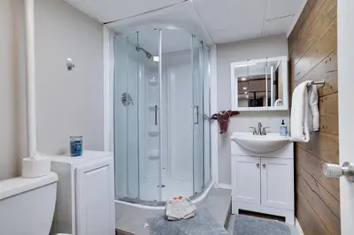 a bathroom with a shower and a sink at Emerald Escape Lake, Theater, Game Room & More! in Long Pond