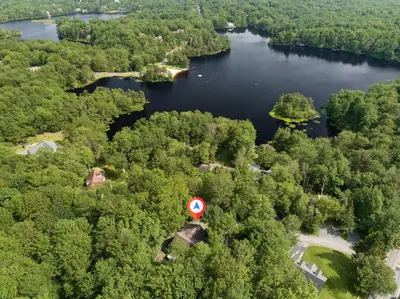 an aerial view of a lake with a red sign at Emerald Escape Lake, Theater, Game Room & More! in Long Pond
