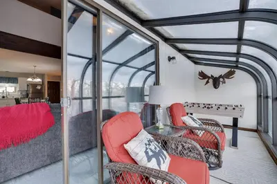 a living room with red chairs and a table at The Cozy Peak 5 Minutes to Ski in Tannersville