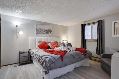 a bedroom with a large bed with red pillows at The Cozy Peak 5 Minutes to Ski in Tannersville