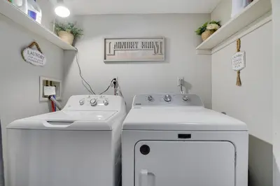 a laundry room with a sink and a washing machine at The Cozy Peak 5 Minutes to Ski in Tannersville