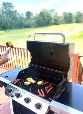 a grill with a bunch of hot dogs on it at The Villa Farm