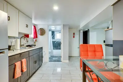 an orange chair in a kitchen with a counter at Apt 2 Mi to Prudential Center and Dtwn Newark! in Newark