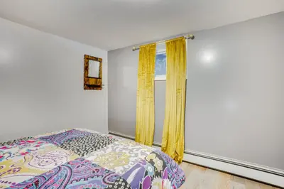 a bedroom with a bed and a window at Apt 2 Mi to Prudential Center and Dtwn Newark! in Newark
