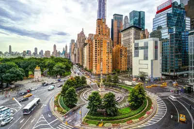 a city street with traffic in a city with tall buildings at Private room by Times Square Manhattan in New York