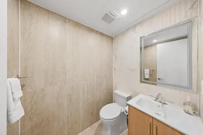 a bathroom with a toilet and a sink and a mirror at Private room by Times Square Manhattan in New York