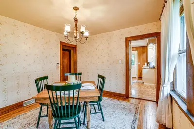 a dining room with a wooden table and green chairs at Home 7 Mi to Binghamton University! in Vestal