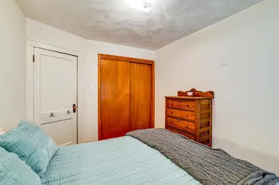 a bedroom with a bed and a wooden door at Home 7 Mi to Binghamton University! in Vestal