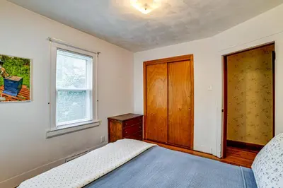 a bedroom with a bed and a wooden door at Home 7 Mi to Binghamton University! in Vestal