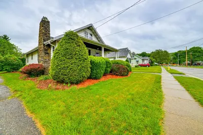 a house with bushes in front of a street at Home 7 Mi to Binghamton University! in Vestal