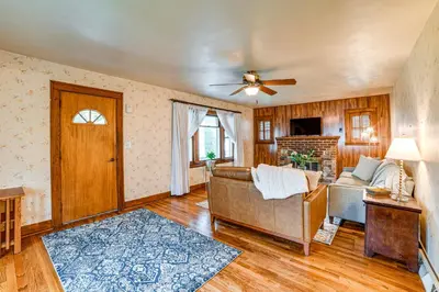 a living room with a couch and a ceiling fan at Home 7 Mi to Binghamton University! in Vestal