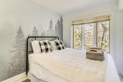 a bedroom with a bed with a snow covered wall at Steps to Jack Frost Ski Resort Townhome with Decks in White Haven