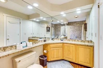 a bathroom with two sinks and a large mirror at Steps to Jack Frost Ski Resort Townhome with Decks in White Haven