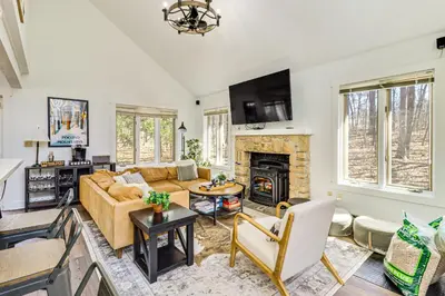 a living room with a couch and a fireplace at Steps to Jack Frost Ski Resort Townhome with Decks in White Haven