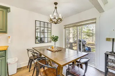 a dining room with a wooden table and chairs at Steps to Jack Frost Ski Resort Townhome with Decks in White Haven