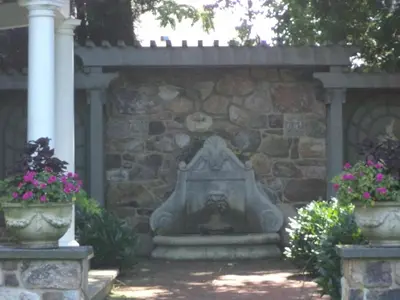 a stone fireplace in a stone wall with two flower pots at The Inn & Spa at Intercourse Village in Intercourse